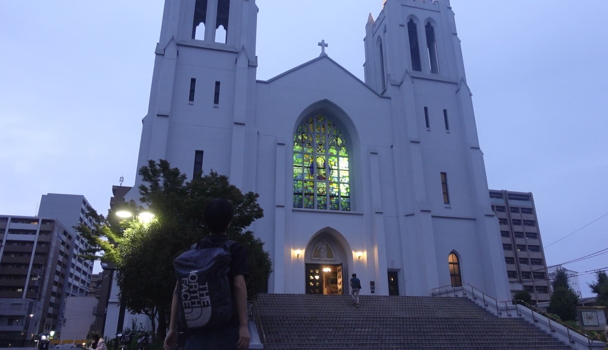 A man standing outside Nunoike Catholic Church in Nagoya, Japan