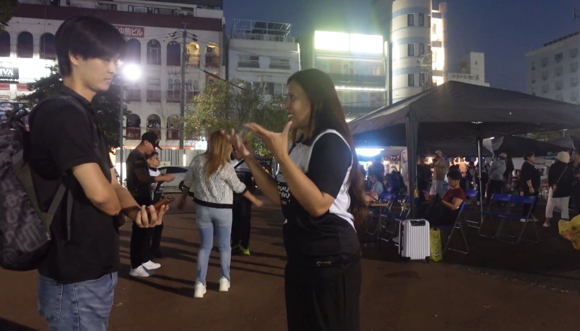 A man and a woman talking during an interview in Nagoya, Japan